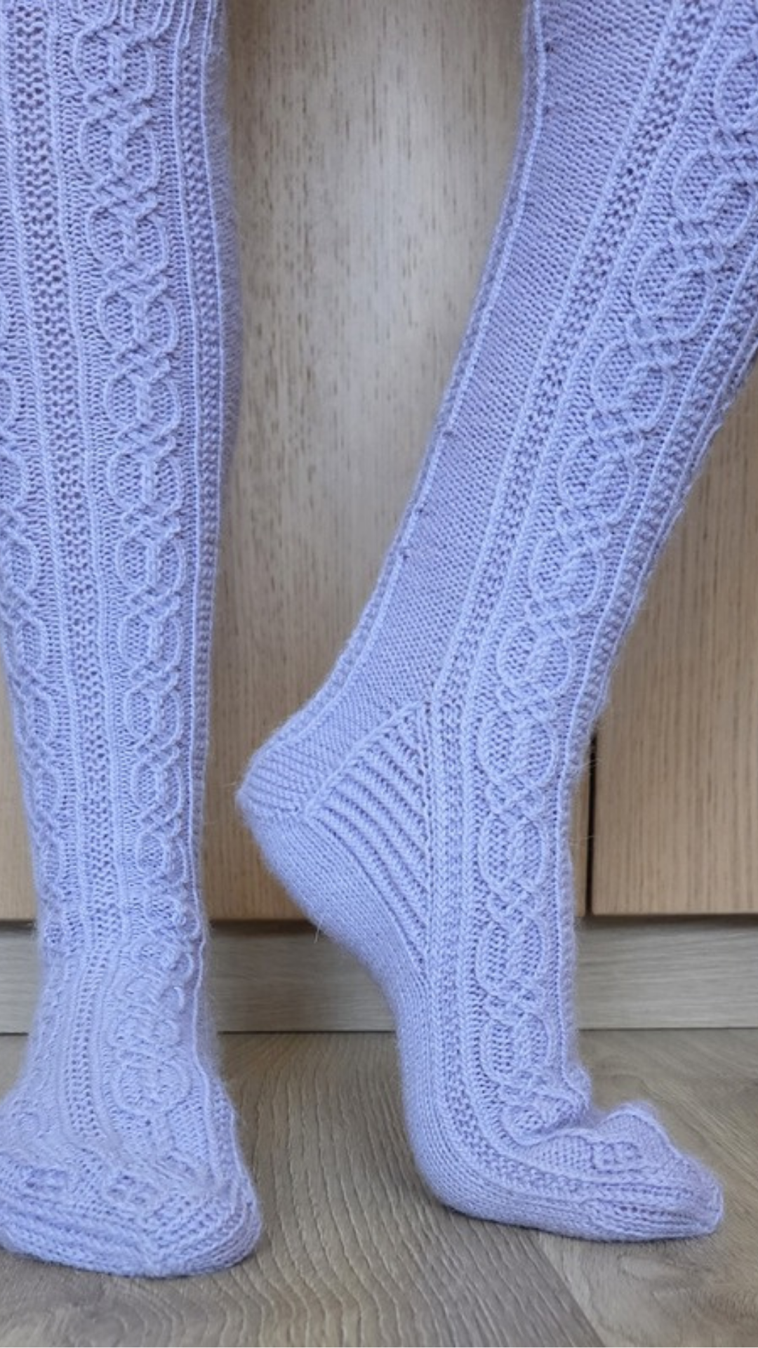 Lorelei knee-high socks with traveling cables, side view showing the patterned heel flap