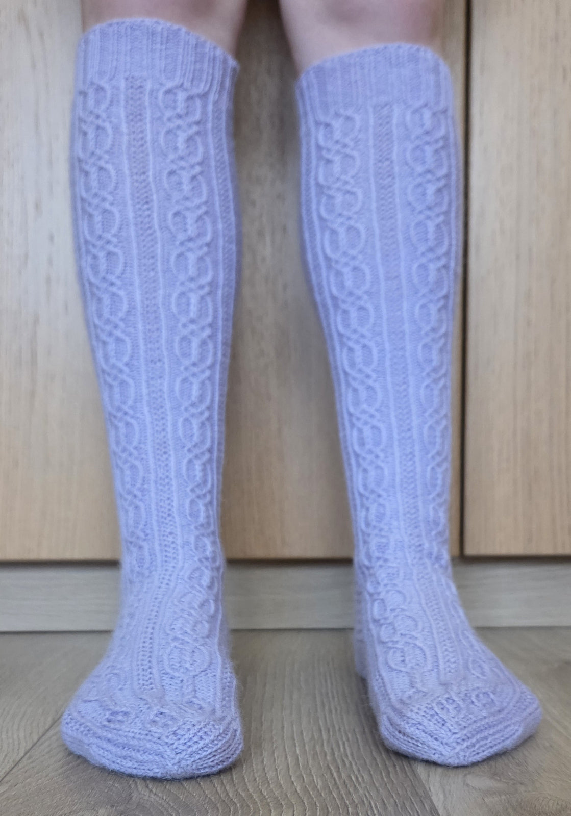Lorelei knee-high socks, front view of the traveling cables